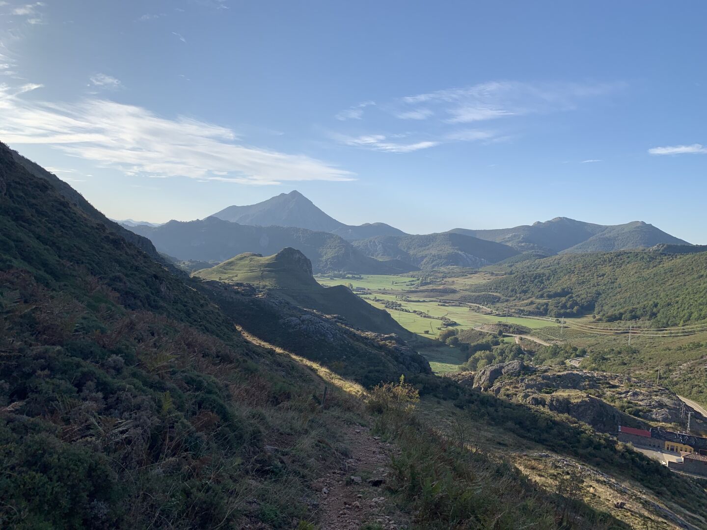 Green rolling hills and mountains on a sunny fall day